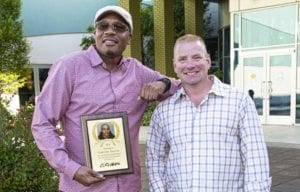 Timothy Taylor, Prime Inc.'s instructor of the year, standing next to his fleet manager Jon Murray.